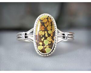 large oval green, gold, orange with dark brown matrix treasure mountain turquoise cabochon bezel set accented twisted wire on silver cuff